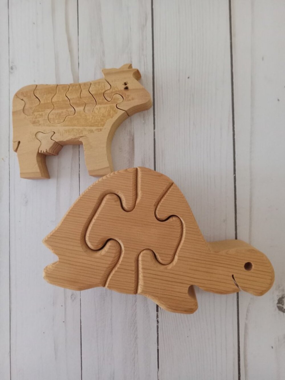 Two unpainted wooden jigsaw animal puzzles
